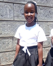 A smiling Wide Horizons student celebrating graduation