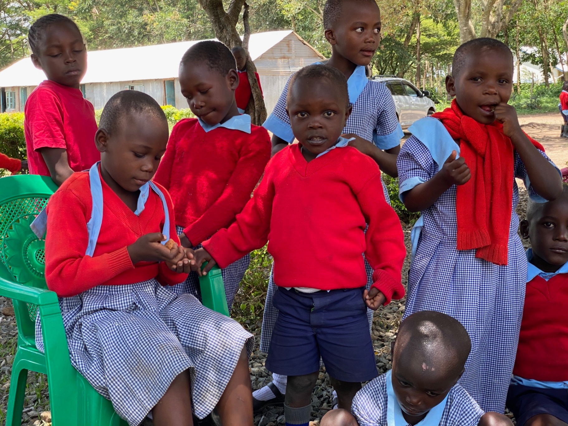 Young Petals of Africa students in their red and blue uniforms gathered together