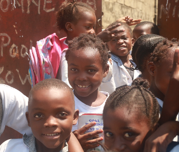 A group of children smiling together at La Tendresse